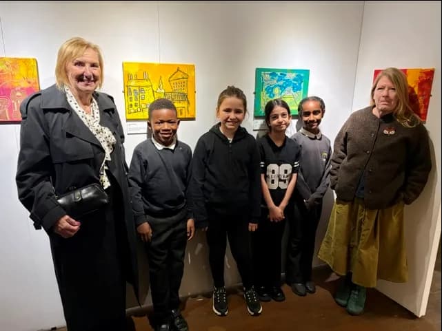 Planning Convener Joan Griffiths (left) with school children and artist Stephanie Walke