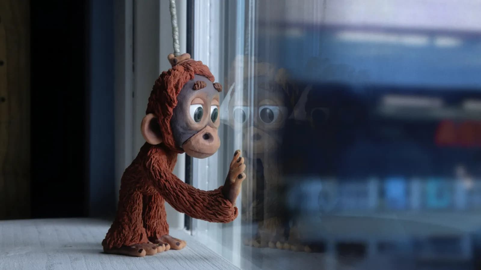 Still from Into the Forest, showing a stop motion monkey at a window