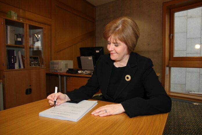 Sturgeon signing the Scottish Independence Referendum Bill 2013