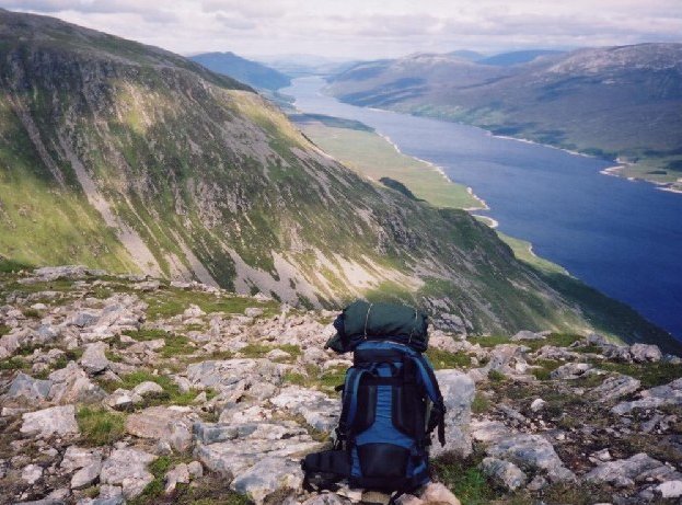 View of Loch Ericht from the summit of Beinn Bheòil, showcasing expansive water surrounded by rugged mountains.

